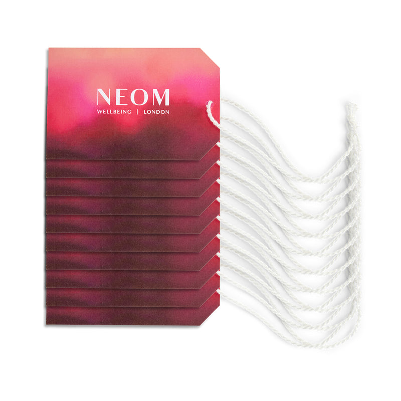 Stack of NEOM skincare products with a white background