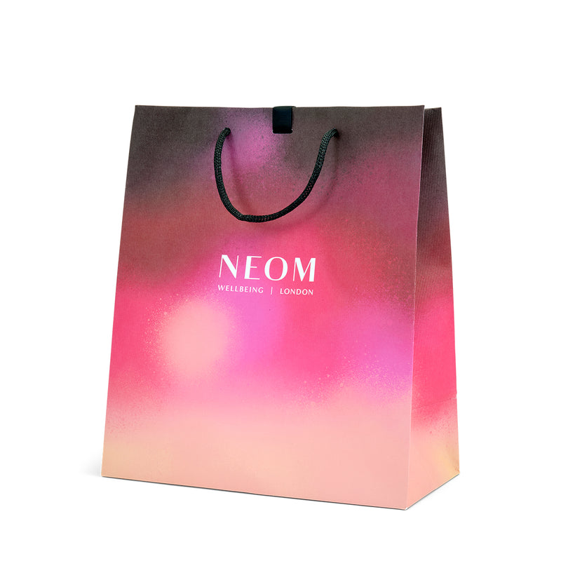 Gradient shopping bag with NEOM branding on a white background