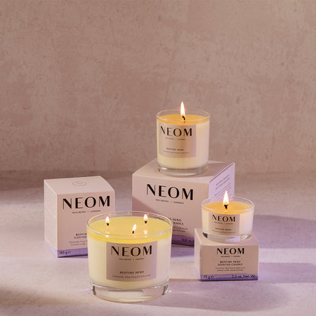 NEOM candles and boxes on a neutral background