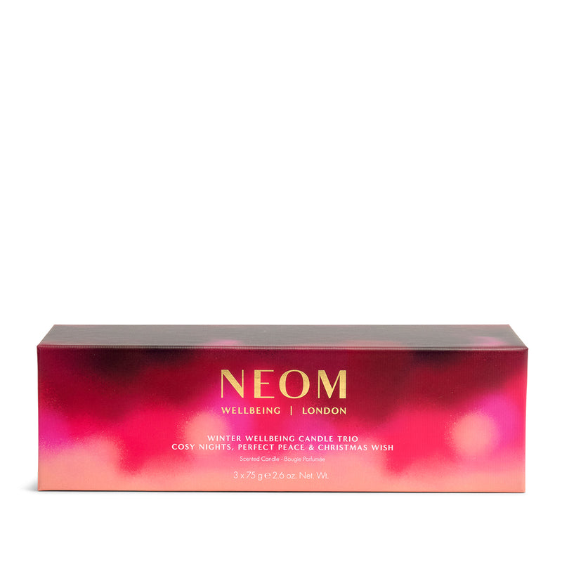 NEOM candle trio packaging with a pink and red gradient on a white background
