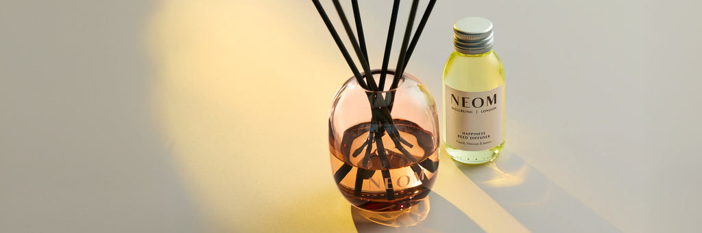NEOM Happiness reed diffuser with refill bottle, neroli, mimosa and lemon fragrance.