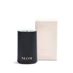 Black NEOM pod mini diffuser and beige box on a white background
