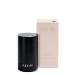 Black NEOM pod mini product with beige box on a white background