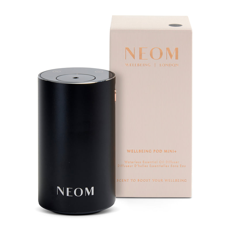 Black NEOM wellness pod and packaging on a white background