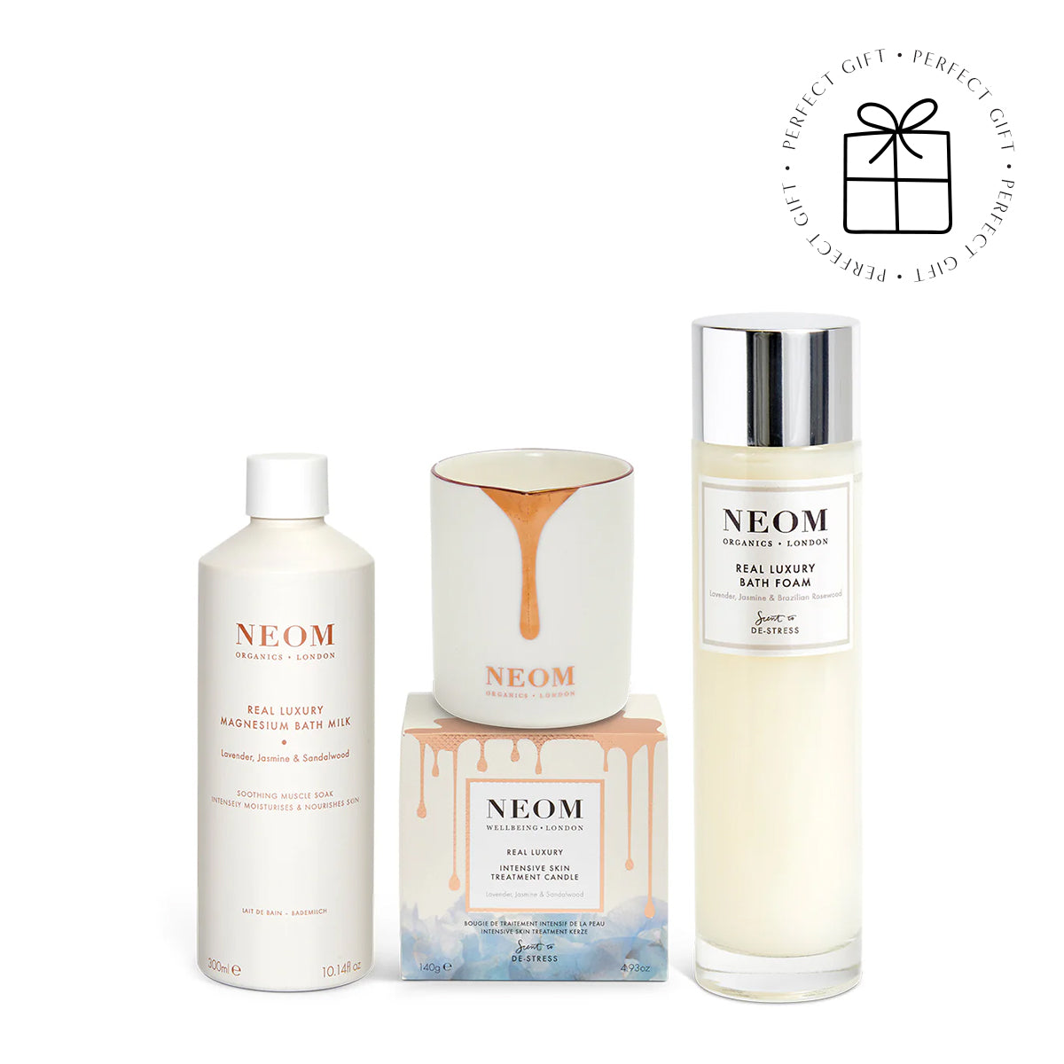 NEOM skincare products including bath foam, bath milk, and candle on a white background