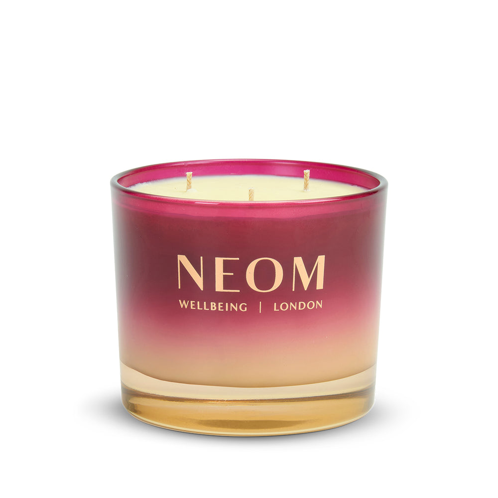 NEOM candle with a gradient design on a white background