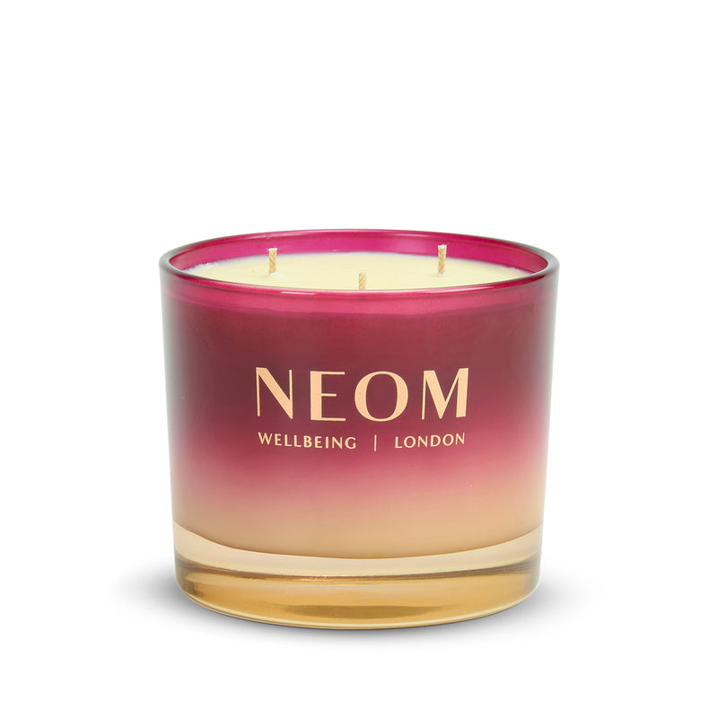 NEOM candle with a gradient design on a white background