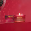 Neom Christmas Wish scented candle on a red background