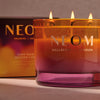 NEOM Cosy NIght's candle with packaging in the background