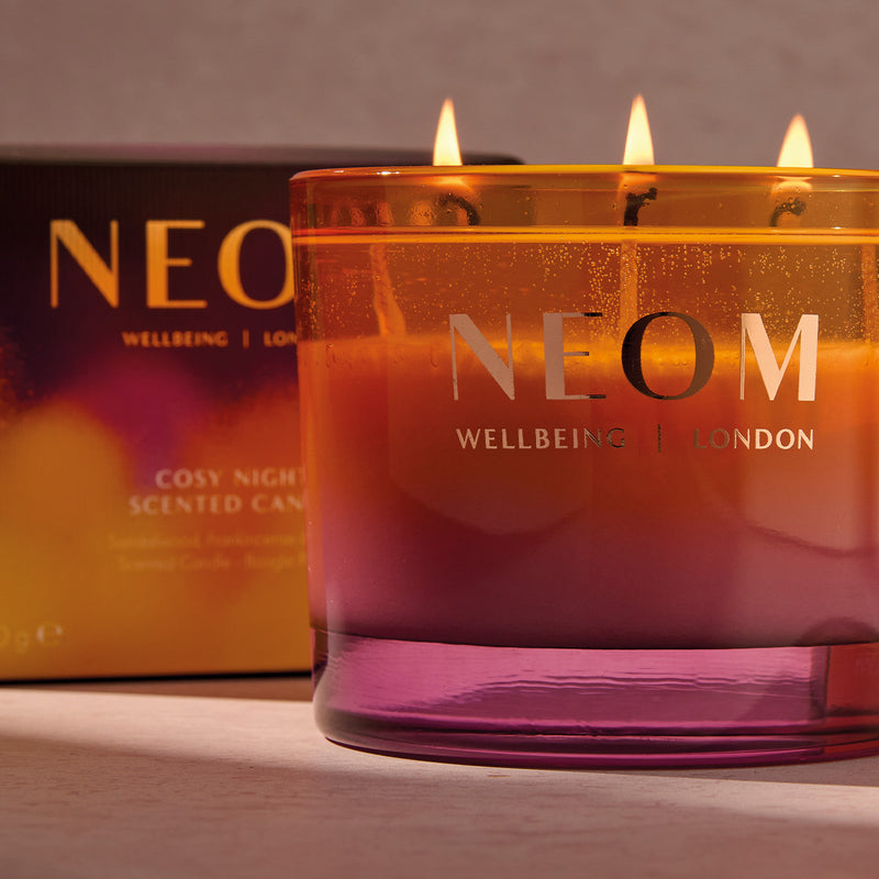 NEOM Cosy NIght's candle with packaging in the background