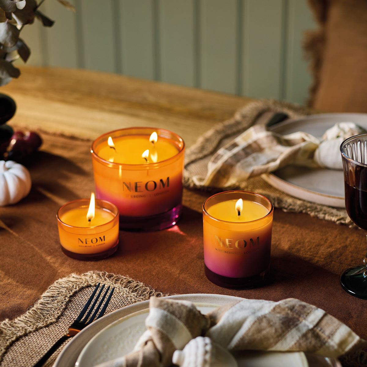 NEOM Cosy Nights candles on a table with a warm setting