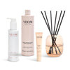 Neom skincare products and diffuser on a white background