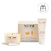 NEOM candle, box, and body butter on a white background