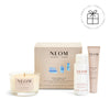 NEOM skincare and candle set on a white background