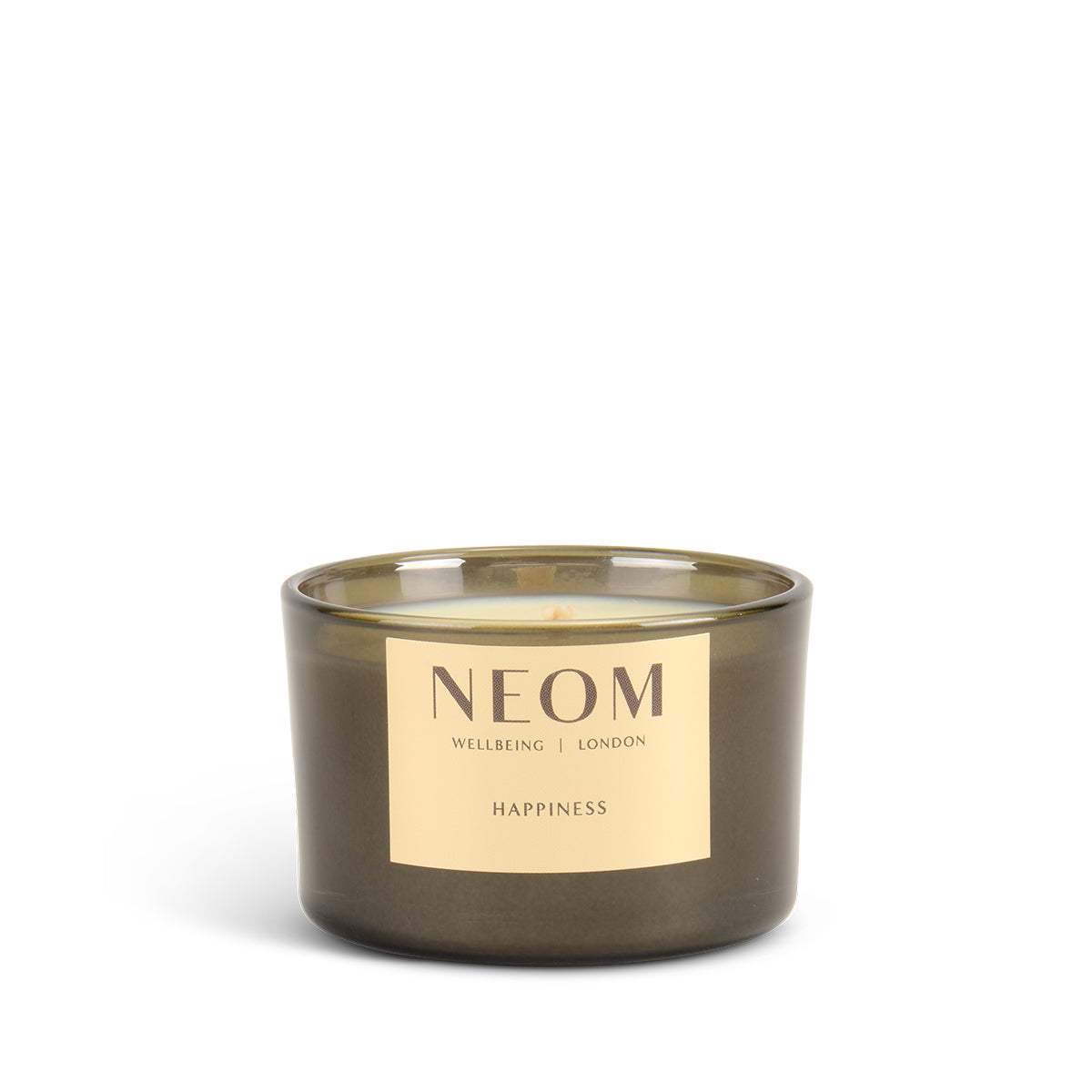 NEOM candle with a gold label on a white background