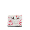 NEOM scented candle packaging with floral design on a white background