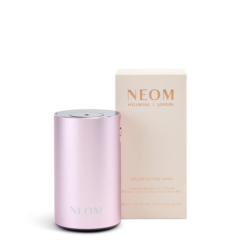 Pink NEOM product with packaging on a white background