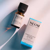 NEOM Moment of Calm essential oil blend bottle with its product box on a light background.