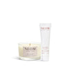 NEOM candle and body milk on a white background