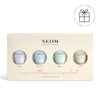NEOM hand balm set with four bottles on a beige box against a white background