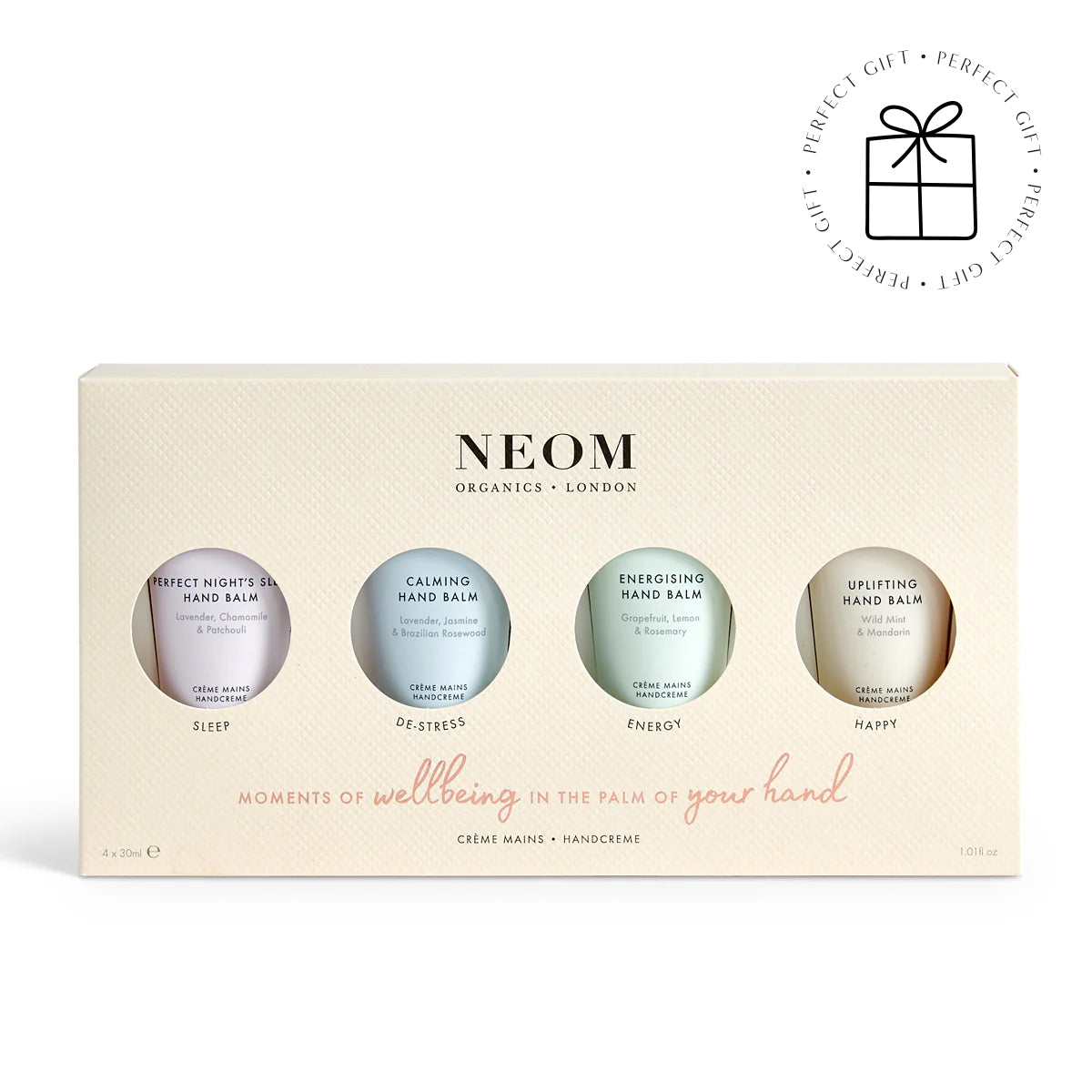 NEOM hand balm set with four bottles on a beige box against a white background