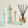 NEOM skincare products and diffuser on a light background