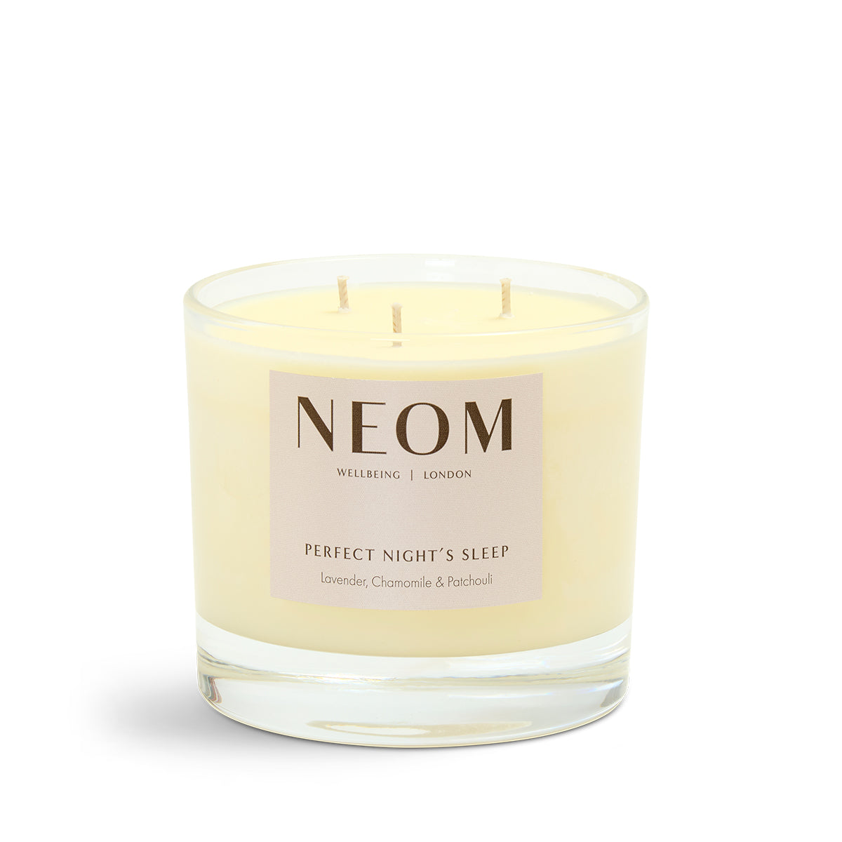NEOM candle with a beige label on a white background