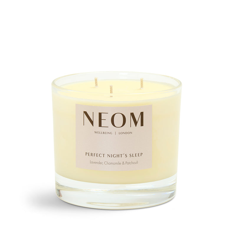 NEOM candle with a beige label on a white background
