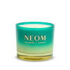 Neom candle with gradient green and yellow design on a white background