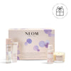 NEOM skincare collection with products and packaging on a white background