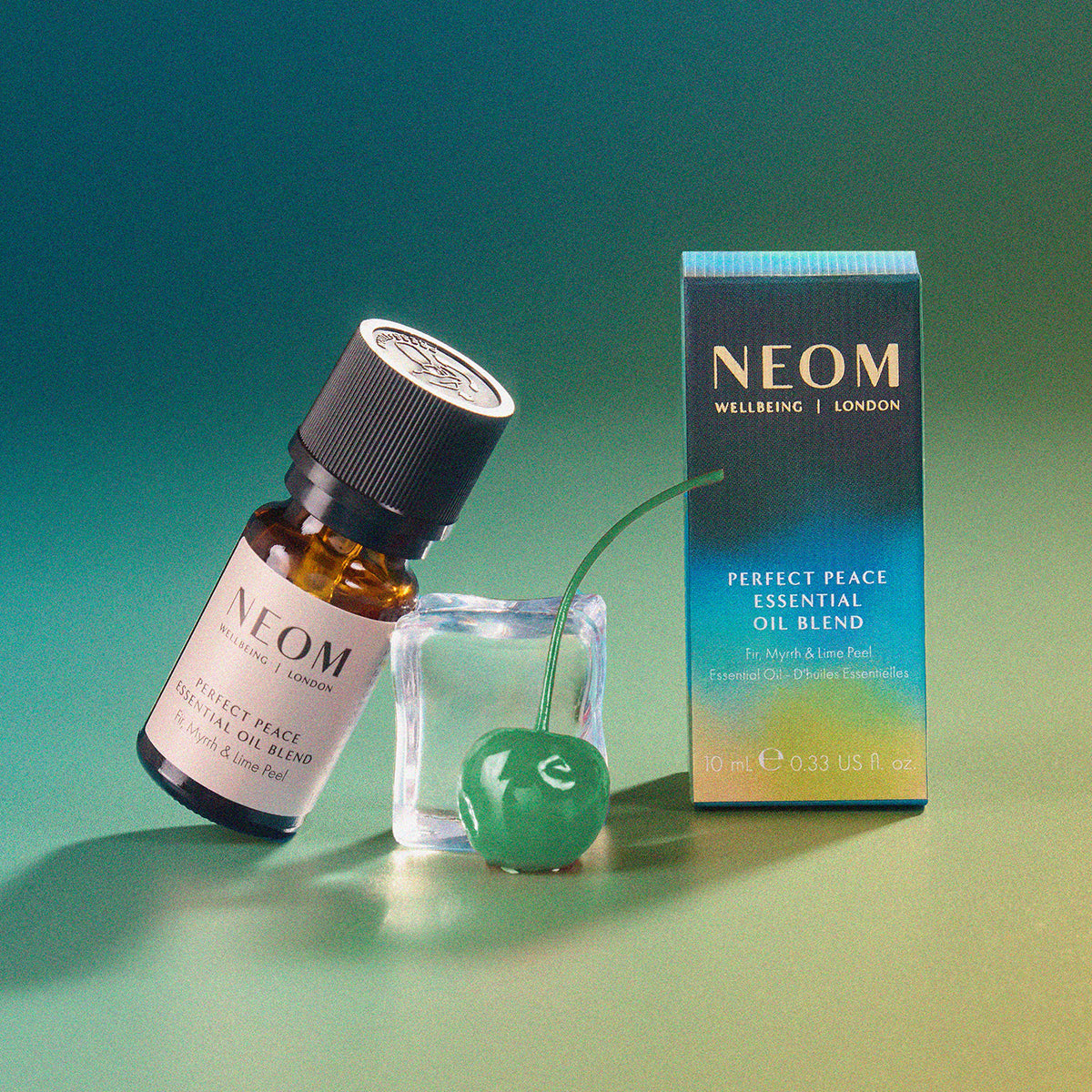 NEOM Perfect Peace Essential Oil Blend with packaging on a gradient green background