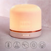 NEOM Pod Luxe with roundels saying :
'REMOTE CONTROL'
'BREATHING MODE'
'TOUCH SENSITIVE'
'LARGER SPACE DIFFUSION'
'NIGHT LIGHT'