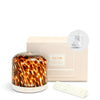 NEOM diffuser with tortoiseshell pattern, packaging, and remote control on a white background