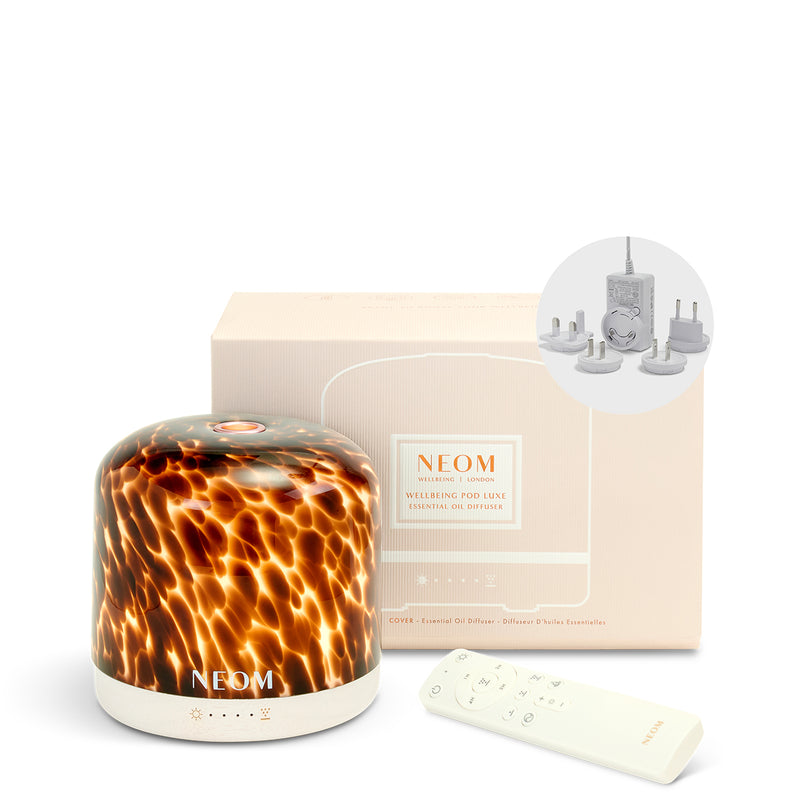 NEOM diffuser with tortoiseshell pattern, remote control, and packaging on a white background