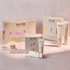 NEOM skincare products including bottles, a candle, and boxes on a light pink background