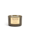 NEOM candle with a gold label on a white background