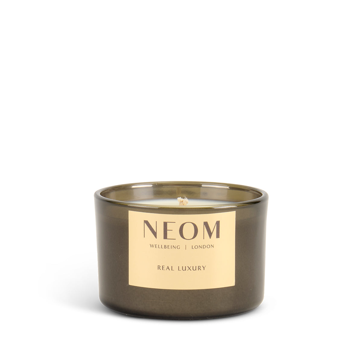NEOM candle with a gold label on a white background
