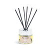 NEOM diffuser with black sticks on a white background