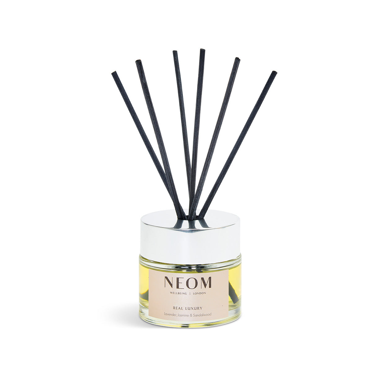 NEOM diffuser with black sticks on a white background