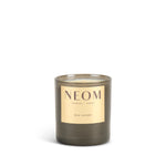 NEOM candle with a gold label on a white background