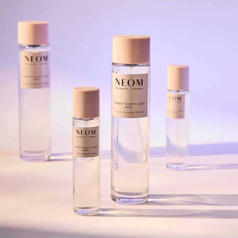 NEOM skincare products on a gradient background
