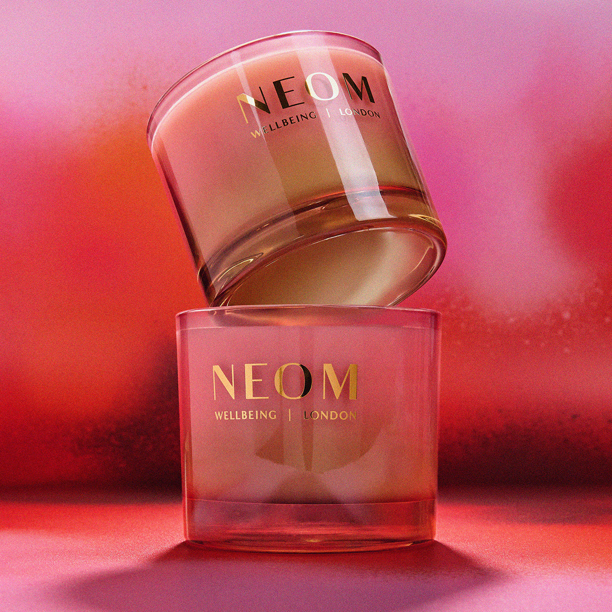 NEOM skincare products on a pink background