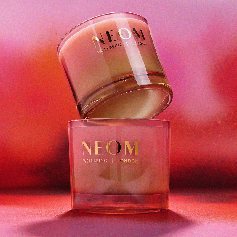 NEOM skincare products on a pink background
