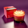 NEOM scented candle with packaging on a purple background