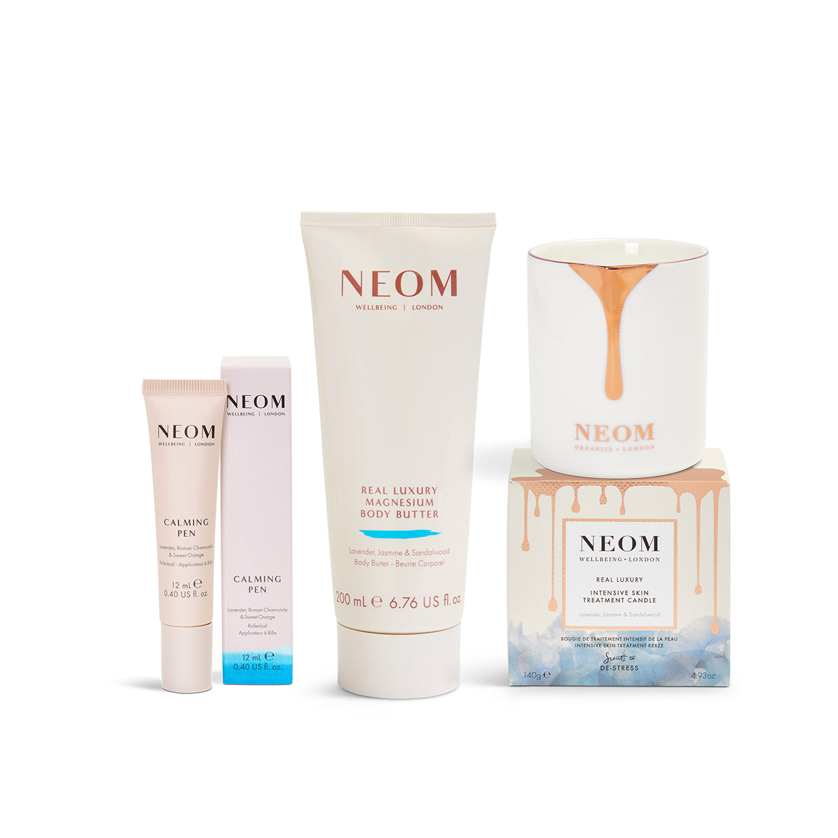 NEOM skincare products including a tube, bottle, and candle on a white background