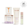 NEOM skincare products including a candle, body butter, and sleep mist on a white background.