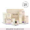 NEOM sleep products including bottles, candles and a box on a white background.