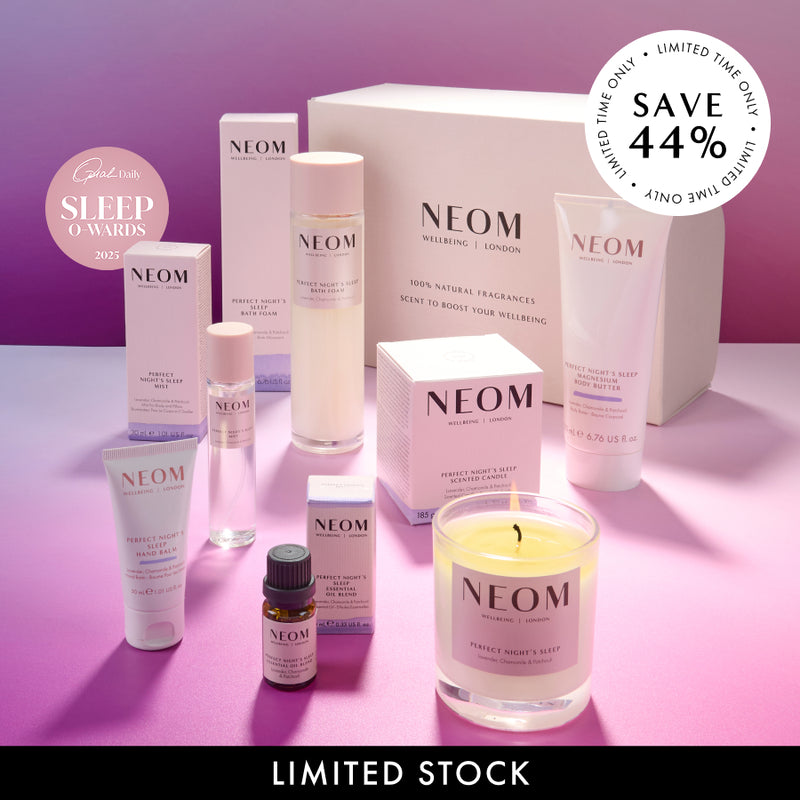 NEOM product line including candles, bottles, and boxes on a pink and purple gradient background.