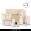 NEOM skincare product set with various bottles and boxes on a white background, featuring a discount offer.
