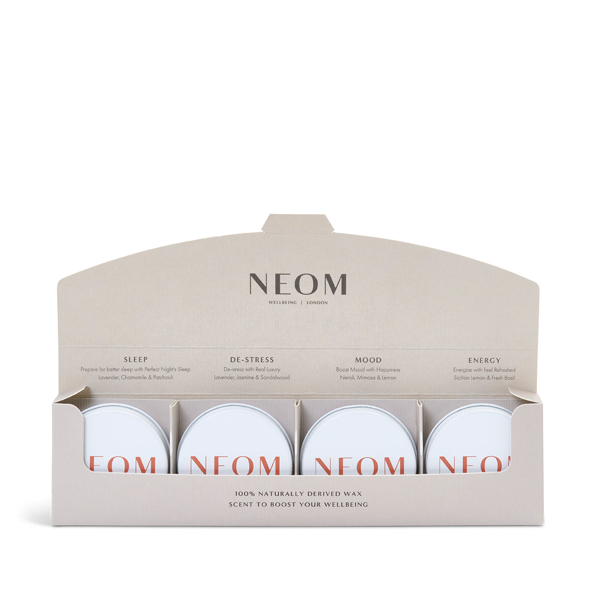 A set of four mini candles from NEOM, displayed in an open box with labels indicating different scents such as 'Sleep', 'De-Stress', 'Mood', and 'Energy'. The candles are hand-poured with 100% naturally derived wax.